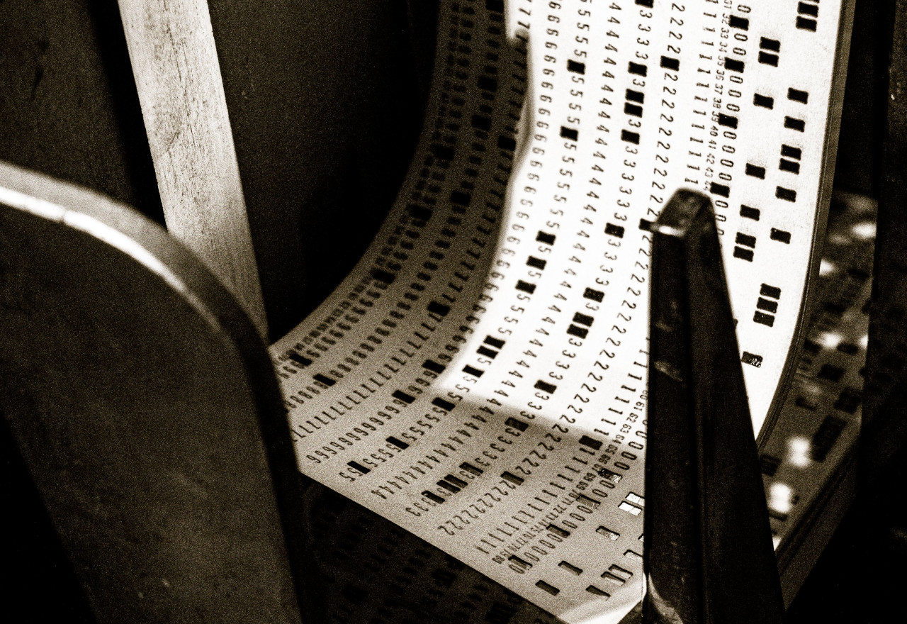 Grayscale shot of an old punch card machine