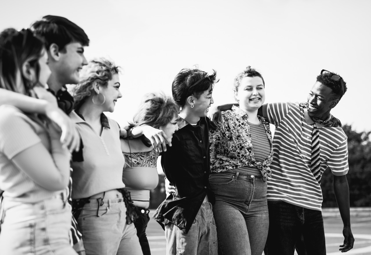 Happy young millennial friends having fun hanging out together -